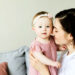 Brunette woman snuggling one year old - Social Media Image
